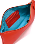 Red clutch bag with open zipper showing blue interior and card holder.