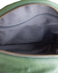 Green bag with a zipper partially open, showing gray interior.