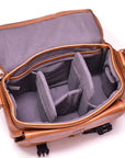 Brown leather bag with gray interior on a white background