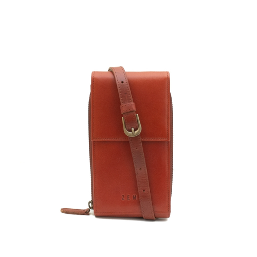 Brown leather crossbody bag with a strap on a white background