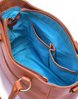 Brown leather handbag with blue interior on a white background