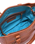 Brown leather handbag with blue interior on a white background