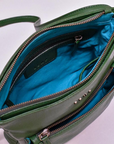 Green handbag with open zipper showing blue interior on a white background