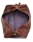 Brown leather bag with a zipper on a white background
