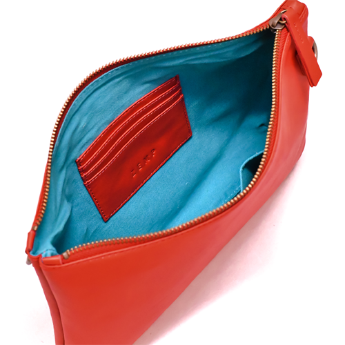 Red clutch bag with open zipper showing blue interior and card holder.
