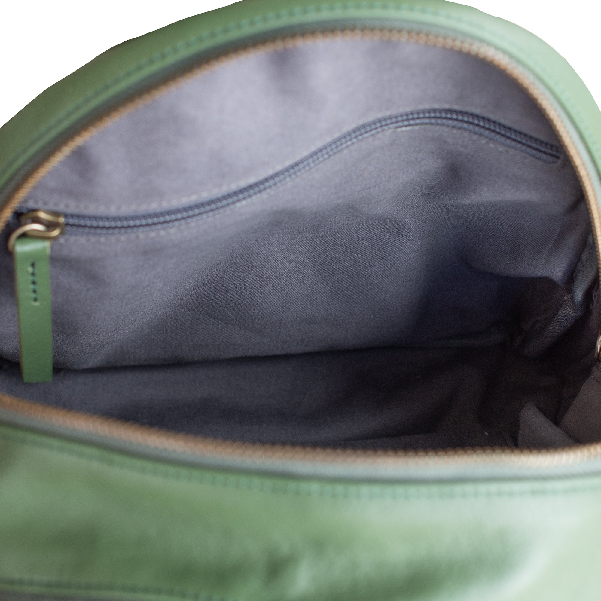 Green bag with a zipper partially open, showing gray interior.