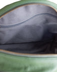 Green bag with a zipper partially open, showing gray interior.