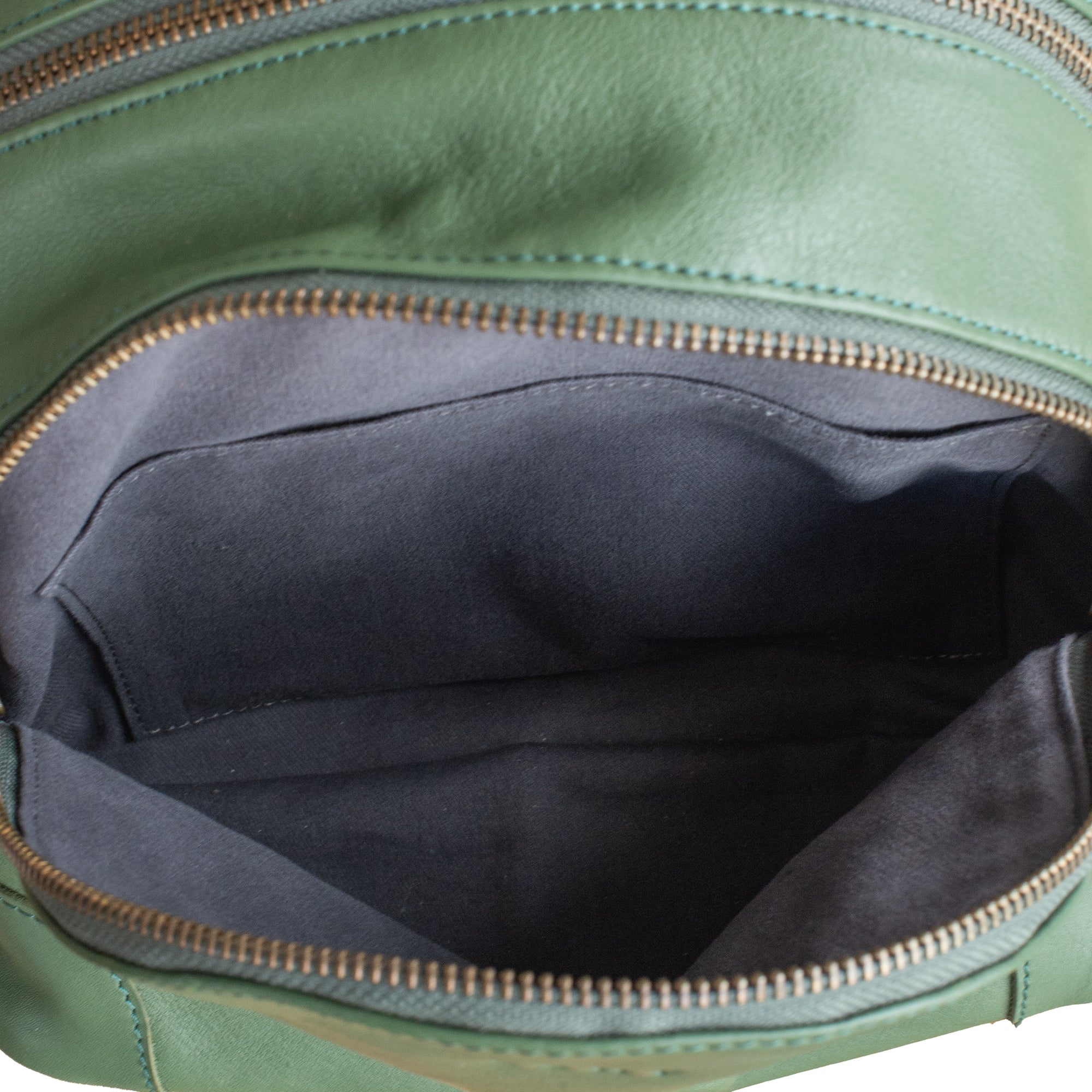 Green leather bag with open zipper showing black interior