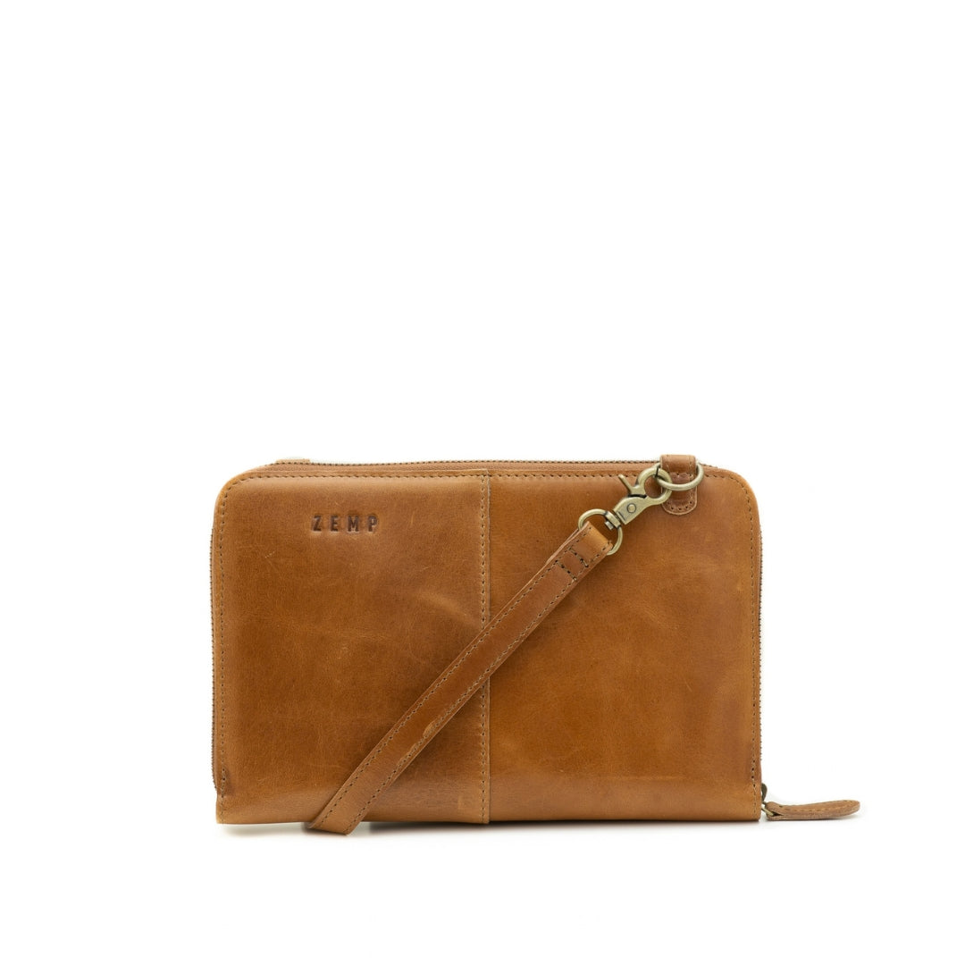 A tan leather zip-around wallet with a matching leather shoulder strap and gold-tone hardware, featuring the debossed brand name 'ZEMP' on the front, set against a plain white background.