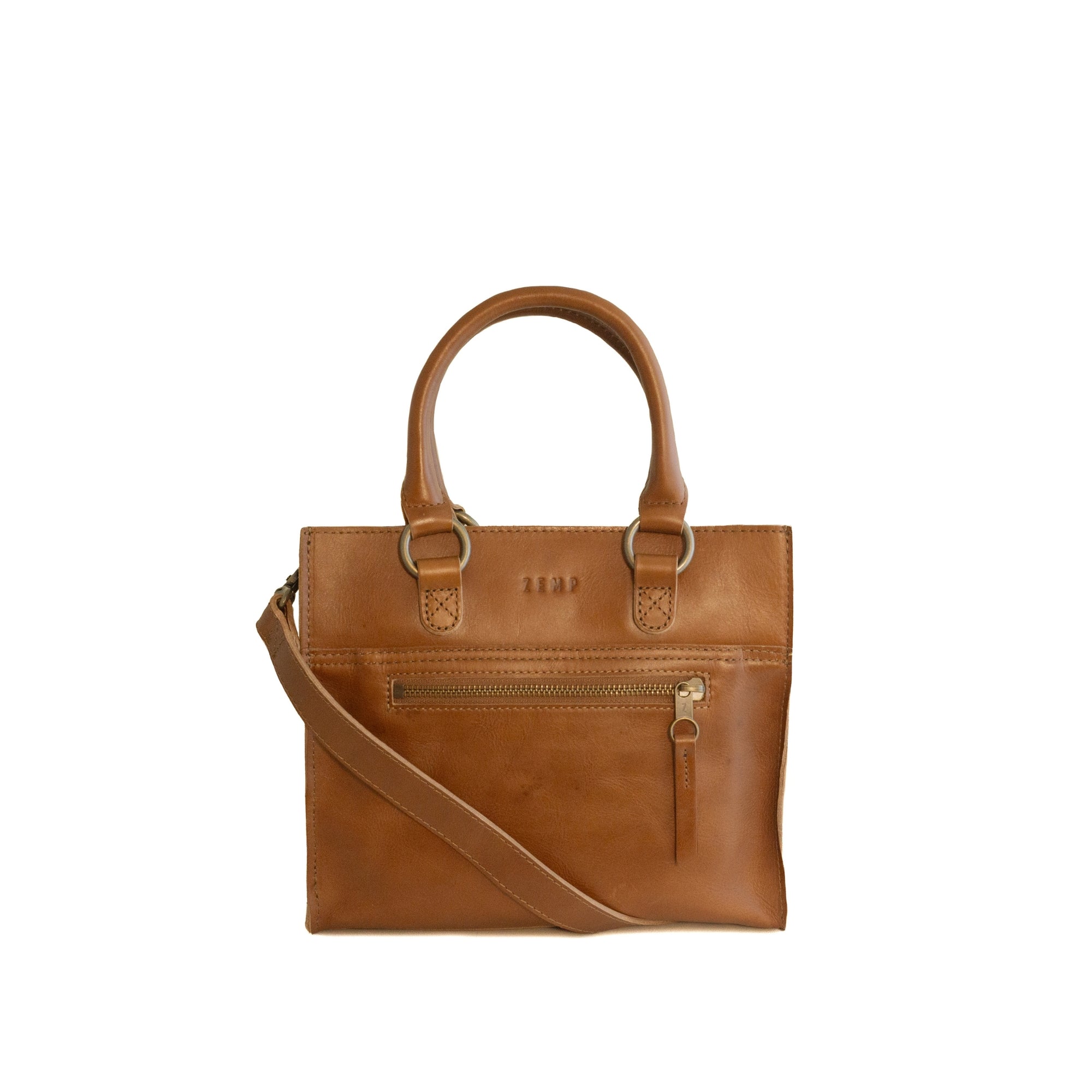 Tan leather handbag with a crossbody strap on a white background
