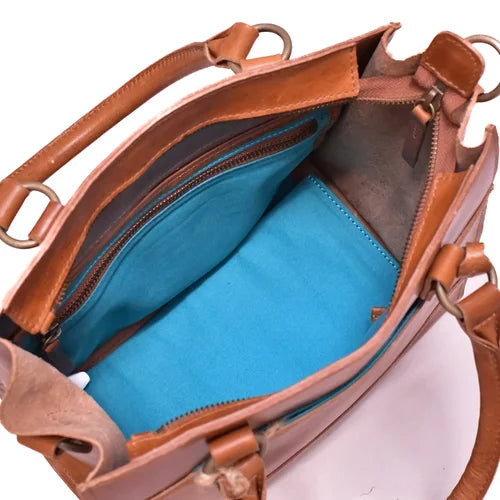 Brown leather handbag with blue interior on a white background