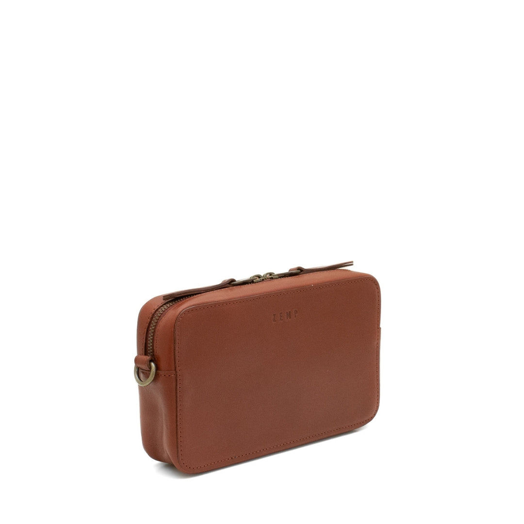 Brown leather bag with a visible brand logo on a white background