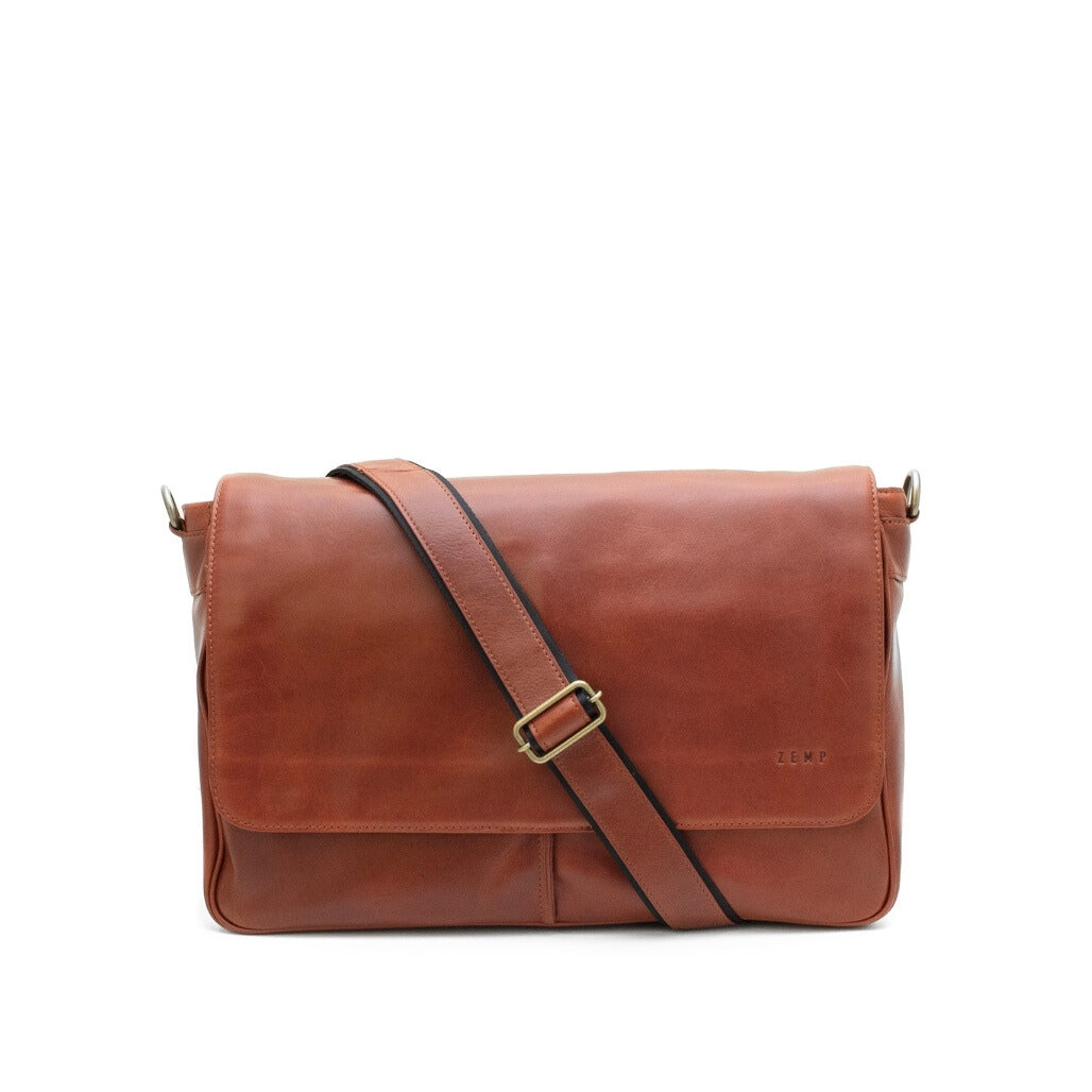 Brown leather messenger bag with a strap on a white background