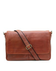 Brown leather messenger bag with a strap on a white background