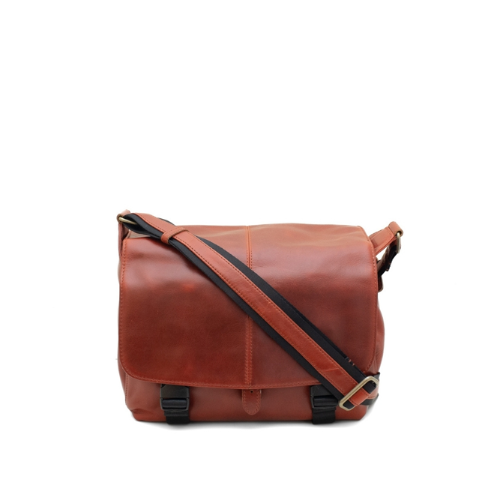 Brown leather messenger bag with black strap on a white background