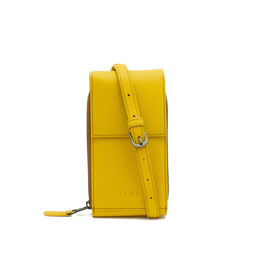 Yellow leather crossbody bag with a strap on a white background