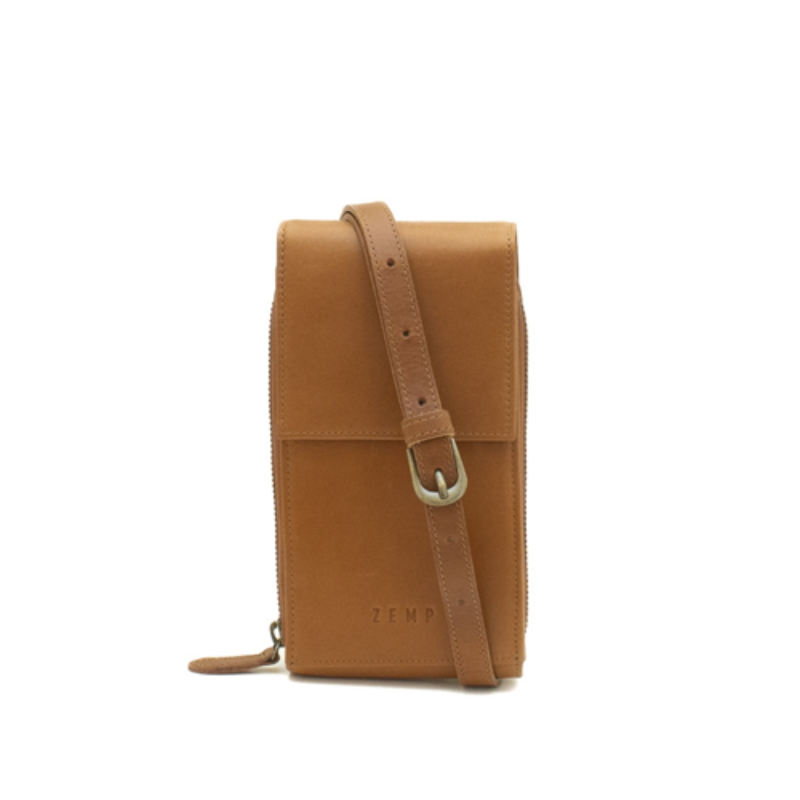Tan leather crossbody bag with a strap on a white background