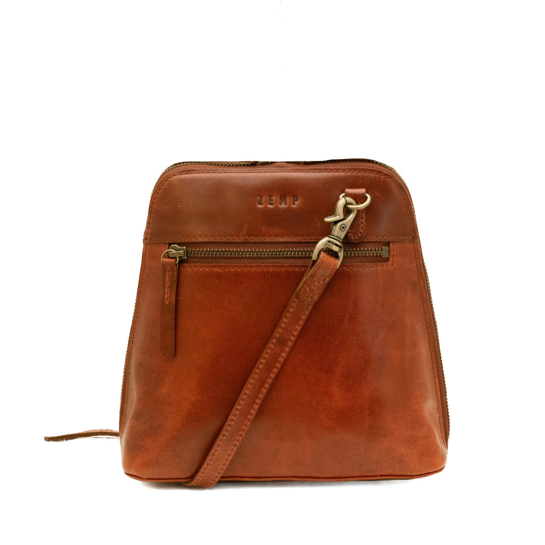 Brown leather crossbody bag with gold zipper on a white background