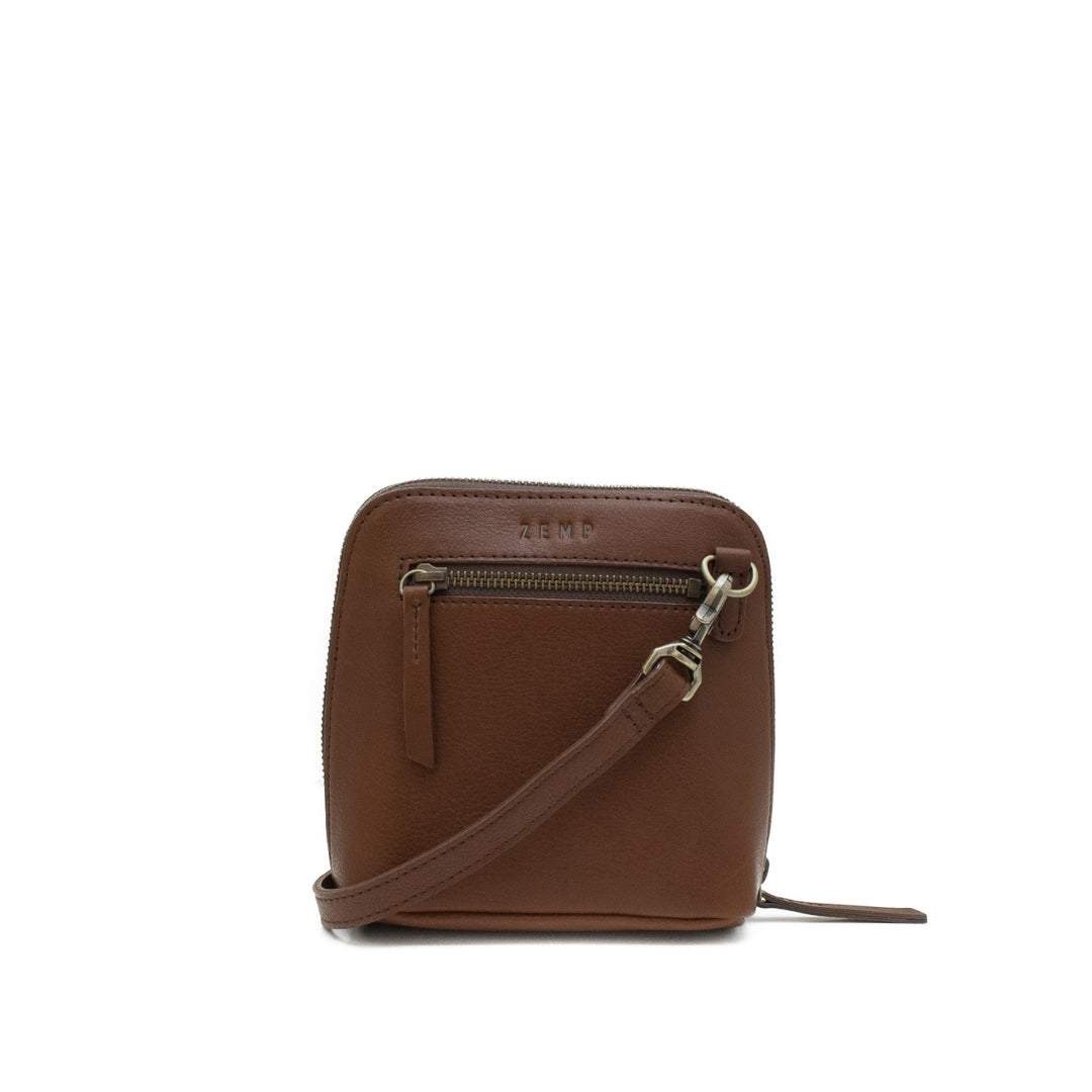 Brown leather crossbody bag with visible brand name on a white background