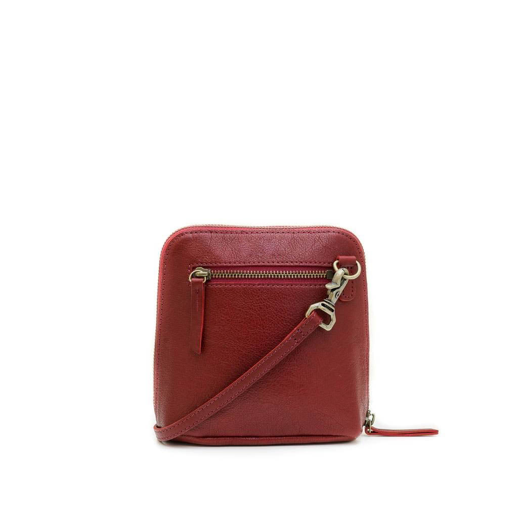 Red crossbody bag with a gold zipper on a white background