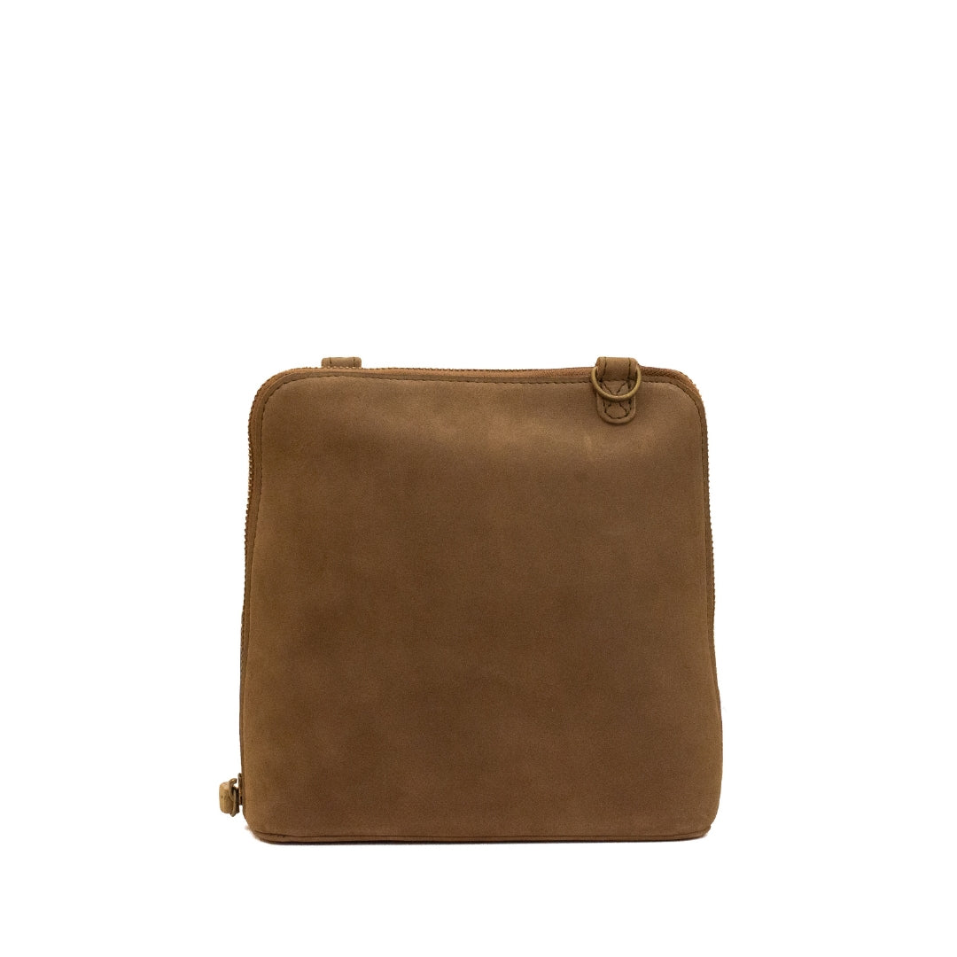 A brown suede or nubuck crossbody bag with a rectangular shape, rounded corners, and a small brass-tone ring detail on the top right, shown against a plain white background.