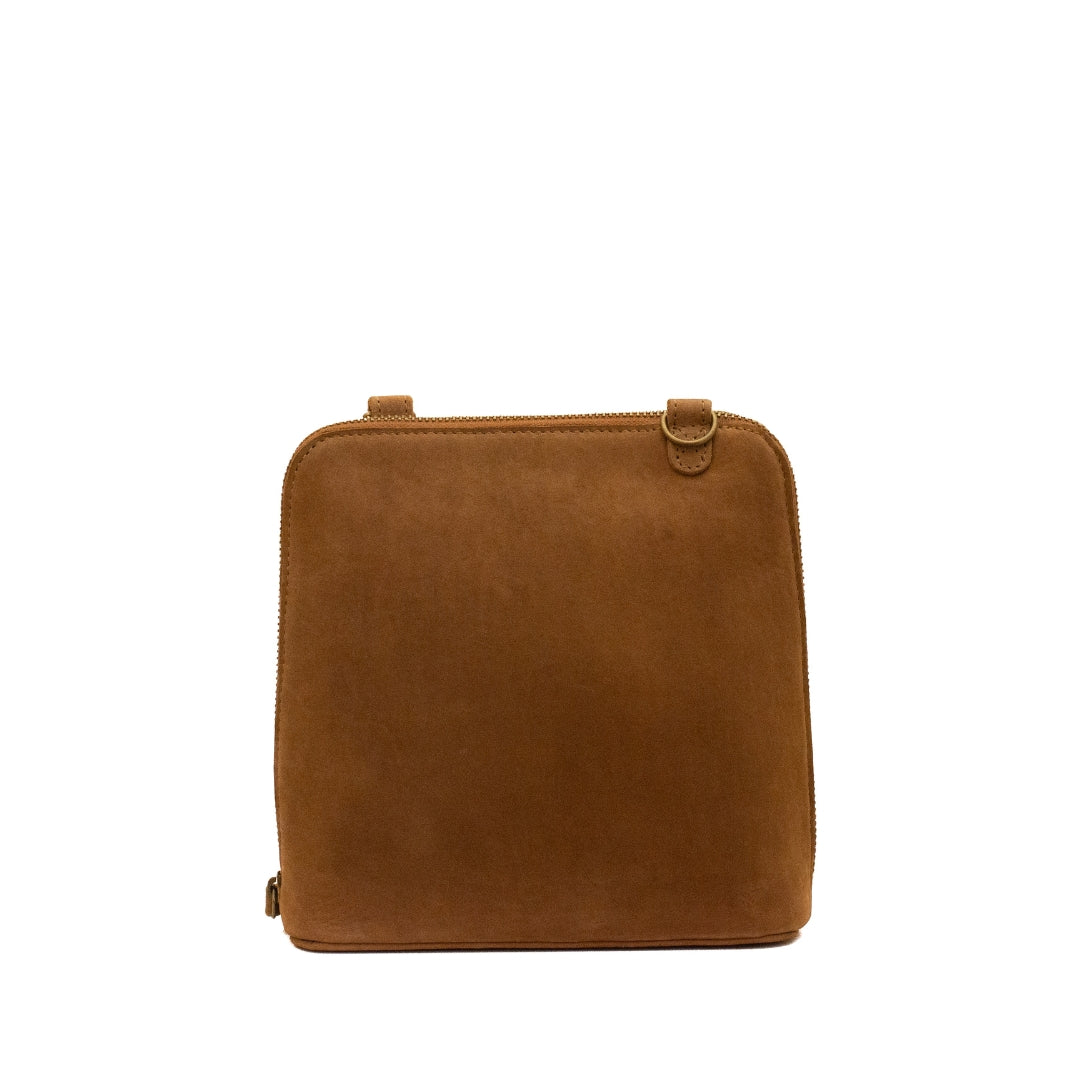 A square-shaped brown suede or faux-suede shoulder bag with a top handle and a small metal ring detail, shown against a plain white background.