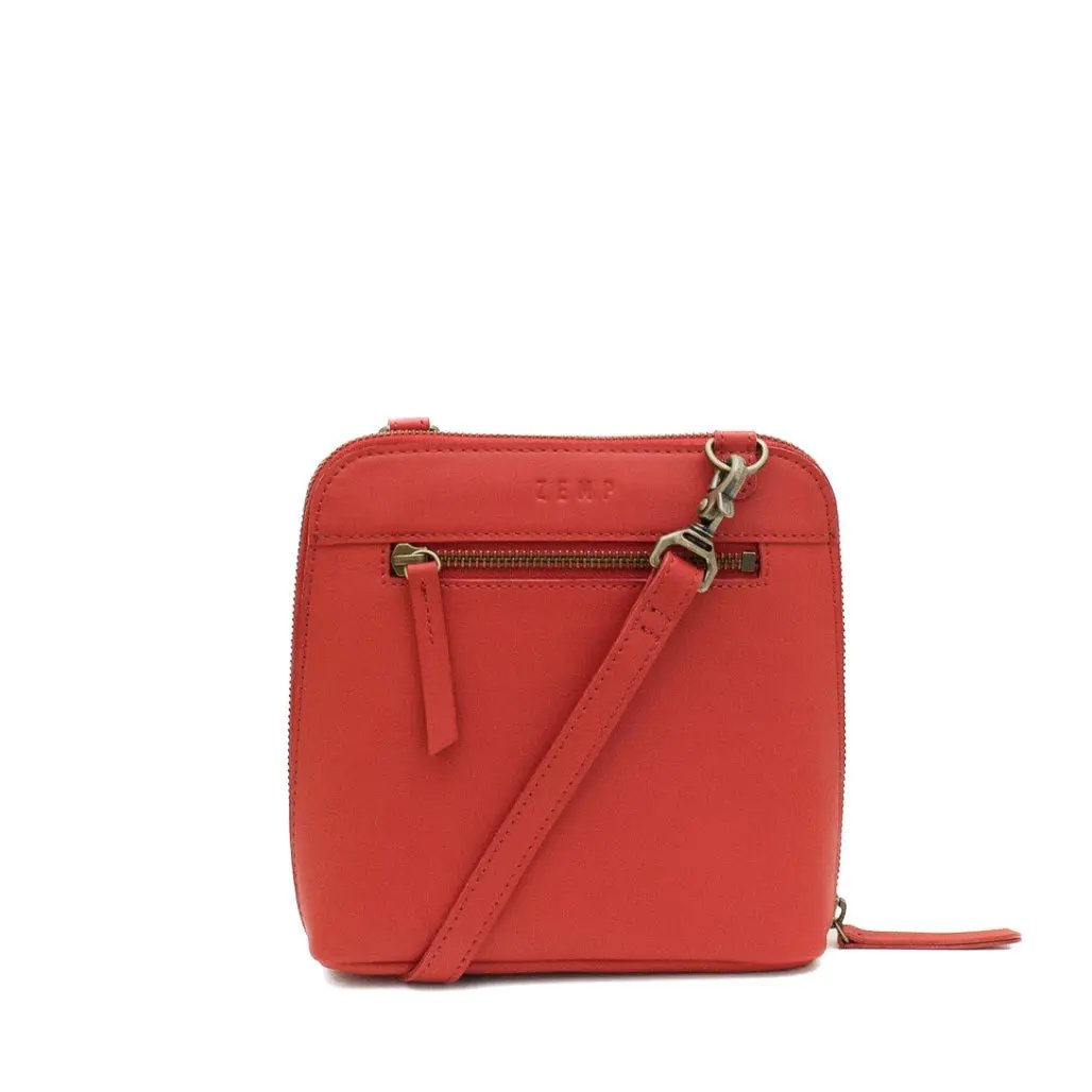 Red crossbody bag with a visible brand logo on a white background