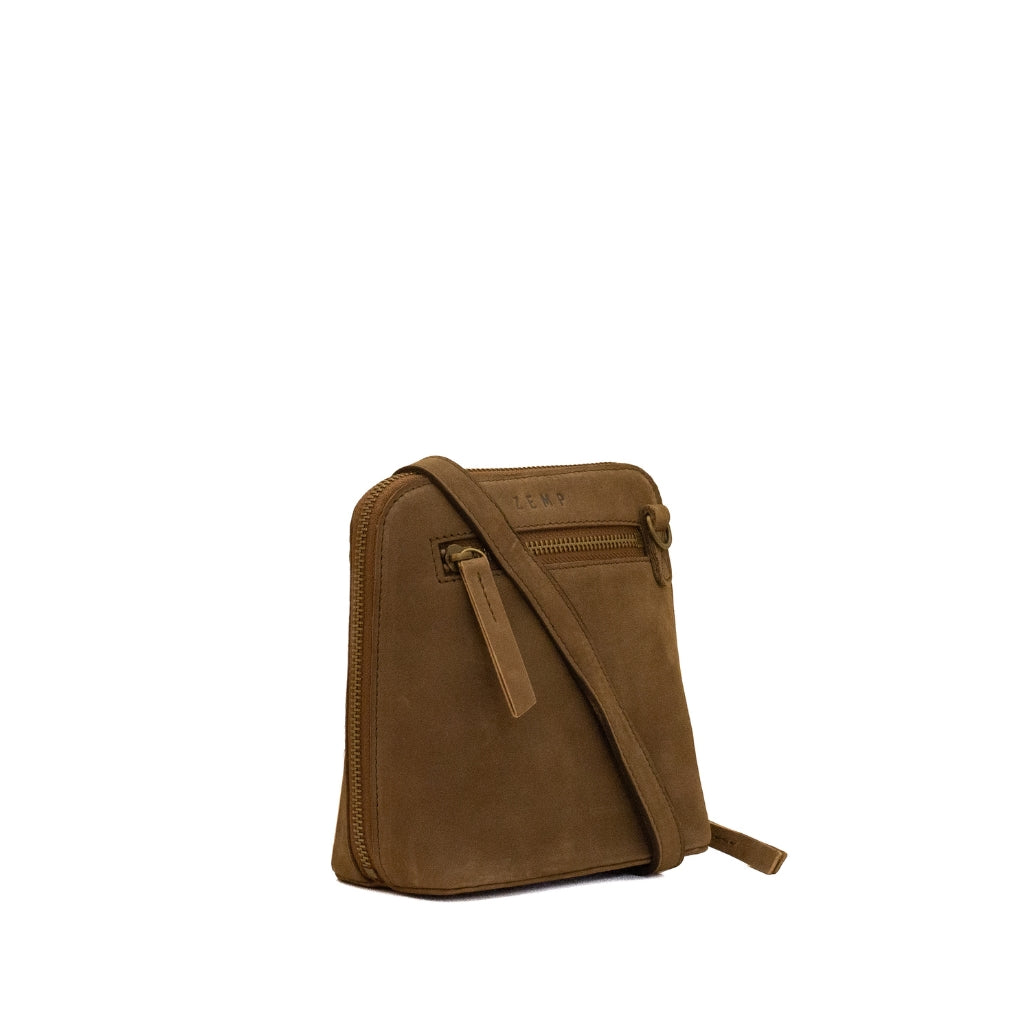 A brown suede crossbody bag with a matching leather strap and zipper pull, shown on a plain white background.