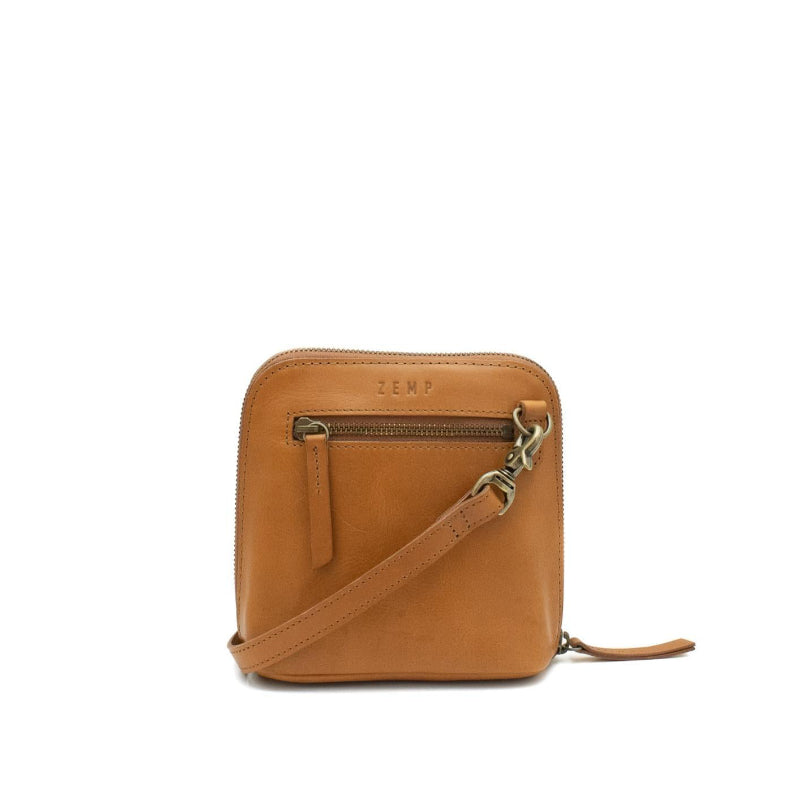 Tan leather crossbody bag with a visible brand logo on a white background