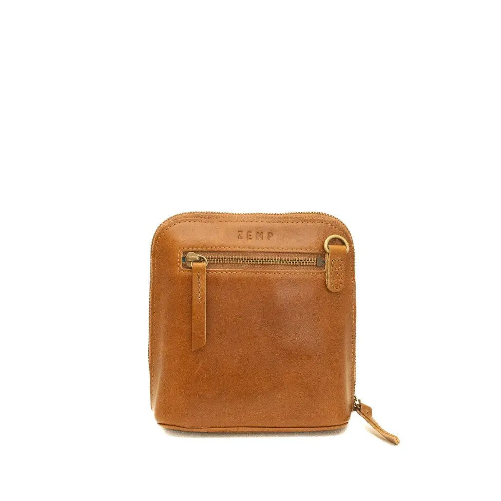 Brown leather pouch with a gold zipper on a white background