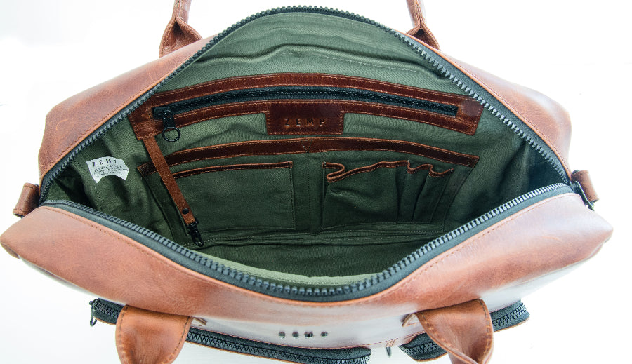 Open leather bag with green interior on a white background