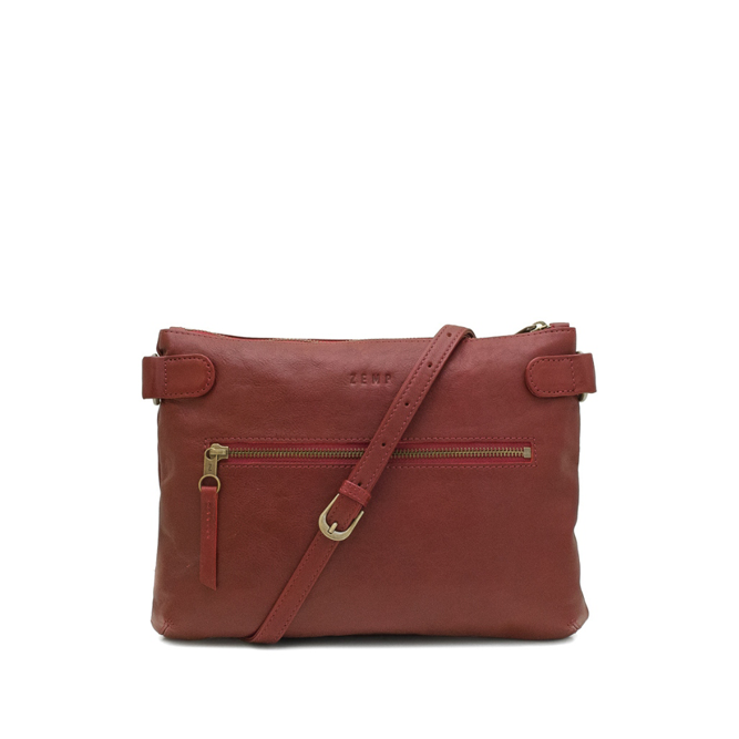 Red leather handbag with a gold zipper on a white background