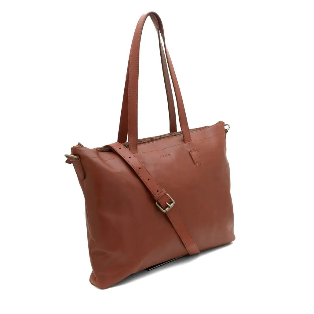 Brown leather tote bag with shoulder strap on a white background