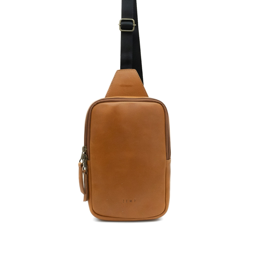 Brown leather sling bag on a white background