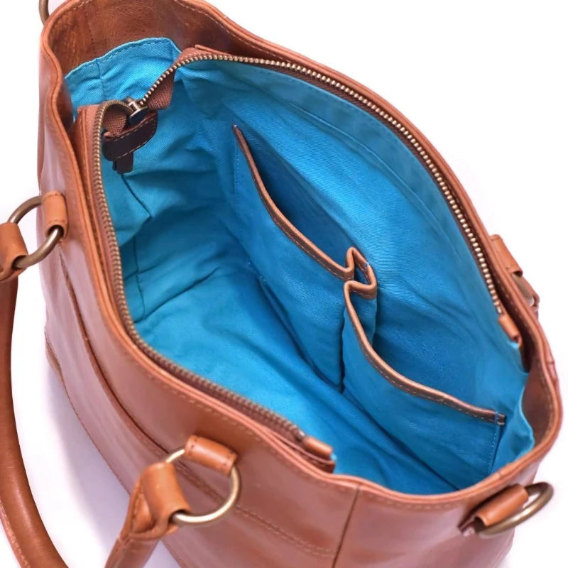 Brown leather handbag with blue interior on a white background