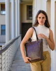 Woman holding a brown tote bag on a balcony