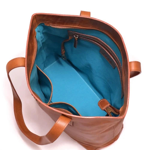 Brown leather bag with blue interior on a white background