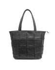 Black woven handbag on a white background
