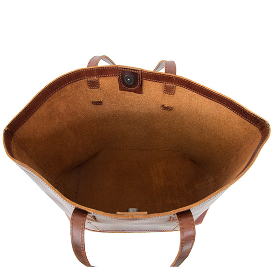 Brown leather tote bag with visible stitching on a white background