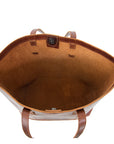 Brown leather tote bag with visible stitching on a white background